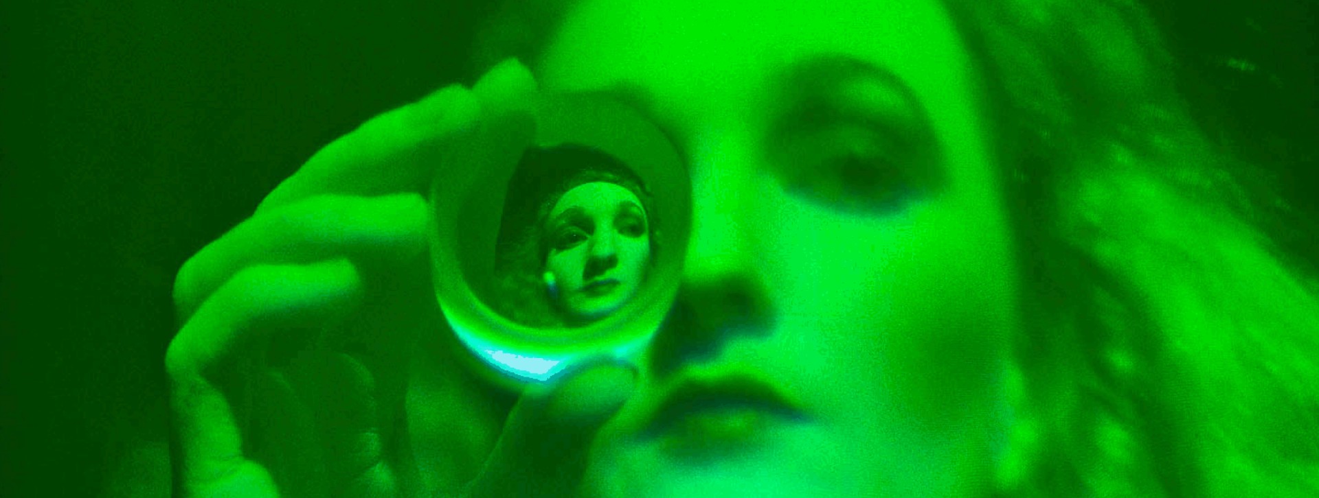 A self-portrait by Edwina Orr who looks at its spectators trough a lens.